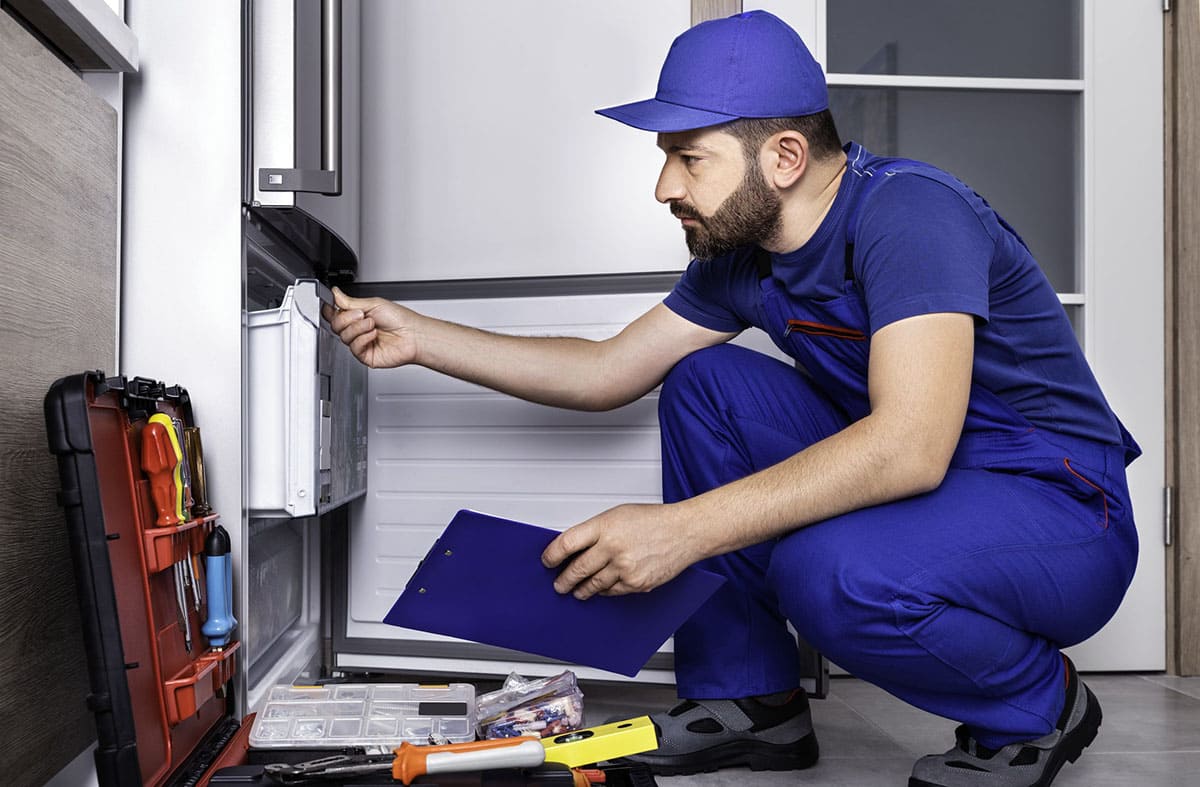 Técnico de neveras en Arona reparando un frigorífico a domicilio en Los Cristianos, Tenerife sur